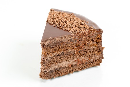 chocolate cake, cocoa biscuit with walnut filling and dark chocolate icing served on a plate.の写真素材