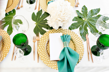 Beautiful banquet hall under a tent for a wedding reception. Interior of a wedding tent decoration ready for guests. Decor flowers. Green themeの写真素材