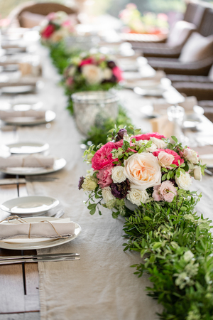 Wedding Banquet or gala dinner. The chairs and table for guests, served with cutlery and crockery. Covered with a linen tablecloth runner. party on terraceの写真素材