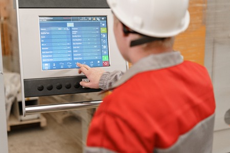 control computer display of Machine. Manufacture workers adjusts the machine in the warehouse. the...