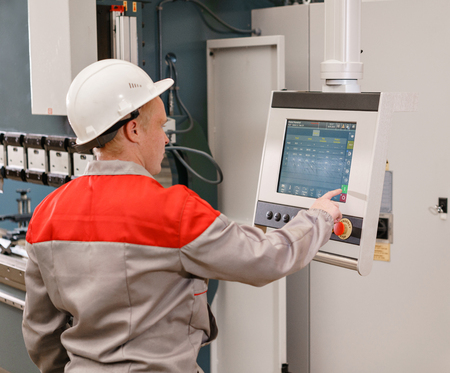 control computer display of Machine. Manufacture workers adjusts the machine in the warehouse. the...