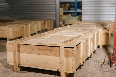 Large wooden boxes. Warehouse of spare parts for machines and mechanisms. Production of ventilation and drainpipeの写真素材