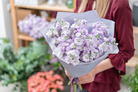 European floral shop. Two Bouquet of beautiful lilac flowers in woman hand. Excellent garden flowers in the arrangement , the work of a professional florist.の写真素材