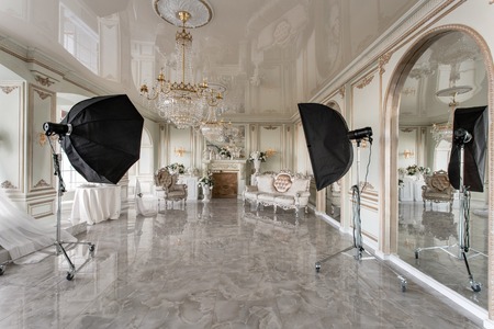 Photo Studio interior. classic luxurious apartments with a white fireplace, sofa, large windows and...
