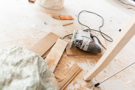 Close-up tools for cuts the laminate Board with an electrofret saw. installing new wooden laminate flooring. concept of repair in house.の写真素材
