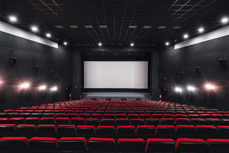 Russia, Nizhny Novgorod - may 23, 2014: Mir Cinema. Empty red cinema hall seats, comfortable and soft chairs. Perspective auditorium view with white space on the screenのeditorial素材