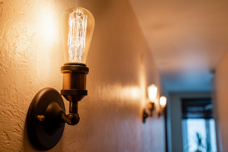 Vintage style light bulbs. glass round bulbs with a spiral on wall.の写真素材