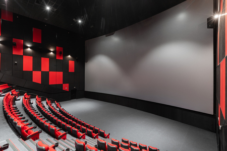 Russia, Nizhny Novgorod - November 14, 2016: Cinema Imperia Grez Nebo, Dolby Atmos. Empty red cinema hall seats, comfortable and soft chairs. Perspective auditorium view with white space on the screenのeditorial素材