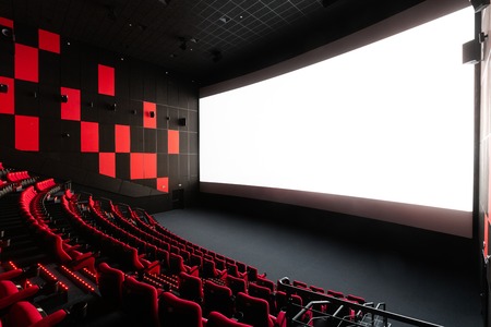 Russia, Nizhny Novgorod - November 14, 2016: Cinema Imperia Grez Nebo, Dolby Atmos. Empty red cinema hall seats, comfortable and soft chairs. Perspective auditorium view with white space on the screenのeditorial素材