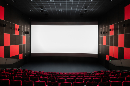 Russia, Nizhny Novgorod - November 14, 2016: Cinema Imperia Grez Nebo, Dolby Atmos. Empty red cinema hall seats, comfortable and soft chairs. Perspective auditorium view with white space on the screenのeditorial素材