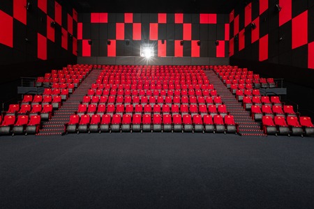 Russia, Nizhny Novgorod - November 14, 2016: Cinema Imperia Grez Nebo, Dolby Atmos. Empty red cinema hall seats, comfortable and soft chairs. Perspective auditorium viewのeditorial素材