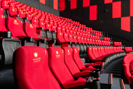 Russia, Nizhny Novgorod - November 14, 2016: Cinema Imperia Grez Nebo, Dolby Atmos. Empty red cinema hall seats, comfortable and soft chairs. Perspective auditorium viewのeditorial素材