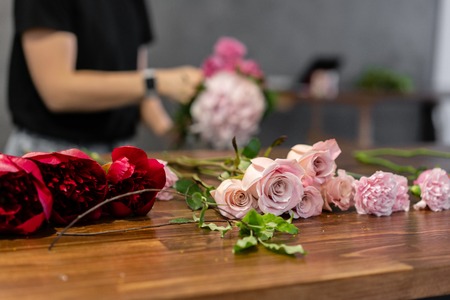 The job of a florist. Master class on making bouquets. Summer bouquet. Learning flower arranging, making beautiful bouquets with your own hands. Flowers deliveryの写真素材