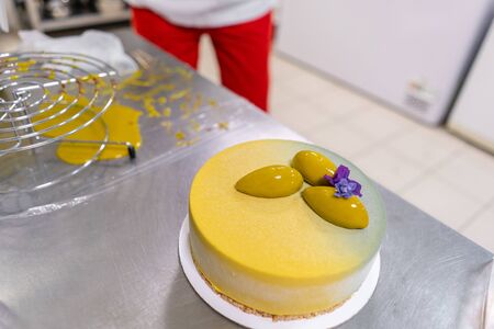 Modern european cake. Mousse dessert covered with yellow velour. Sweet dessert and tea party. French...