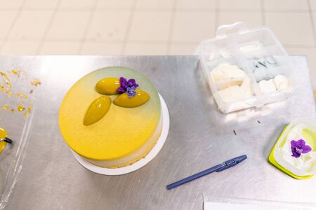 Modern european cake. Mousse dessert covered with yellow velour. Sweet dessert and tea party. French...