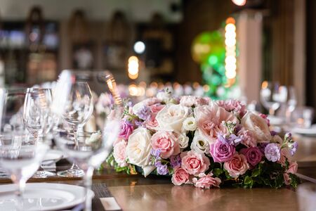 Wine glasses in the foreground. Wedding Banquet or gala dinner. The chairs and table for guests,...