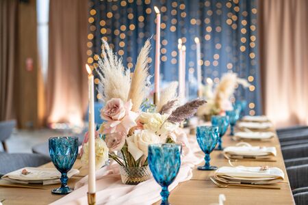 Candles in the foreground. Luxury dinner Banquet in the restaurant. Beautiful and exquisite decoration of the wedding celebration.の写真素材
