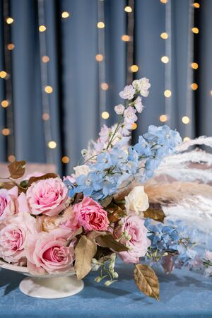 luxury dinner Banquet in the restaurant. Beautiful and exquisite decoration of the wedding celebration. Banquet served table with a beige pink tablecloth, plates and candlesticks with candles.の写真素材