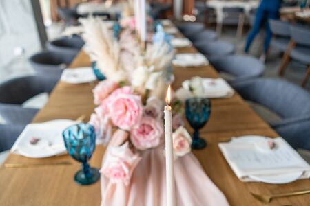 Candles in the foreground. Luxury dinner Banquet in the restaurant. Beautiful and exquisite decoration of the wedding celebration.の写真素材