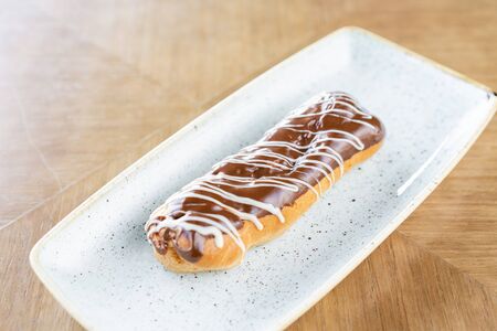 Traditional french eclairs with chocolate. Cake decorated with chocolate cream on top of are on a...