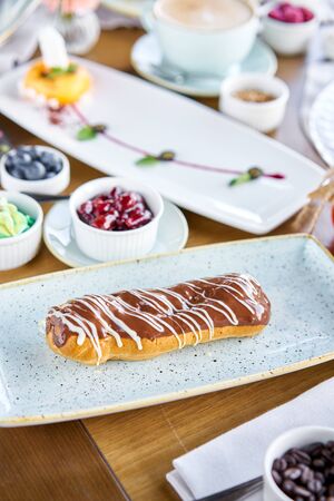 Traditional french eclairs with chocolate. Cake decorated with chocolate cream on top of are on a...