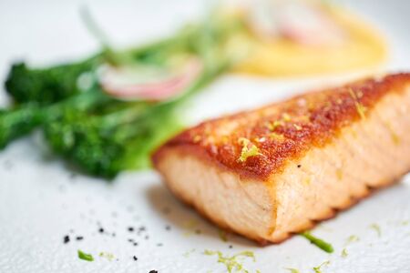 Salmon steak fillet and garnished with young broccoli. Restaurant menu, a series of photos of different dishesの写真素材