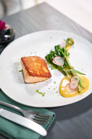 Salmon steak fillet and garnished with young broccoli. Restaurant menu, a series of photos of different dishesの写真素材