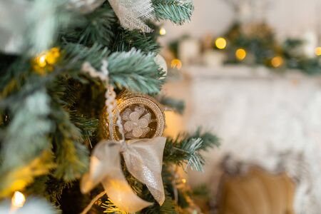 Closeup of Christmas tree branches with decorative balls, ribbon bows, snowflakes, pine cones and lights.の写真素材