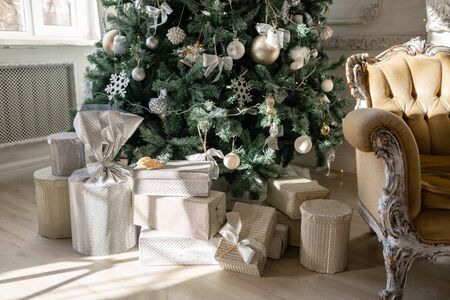 Many Christmas gifts under tree with ornaments. Christmas balls, ribbon bow, snowflakes, pine cones...