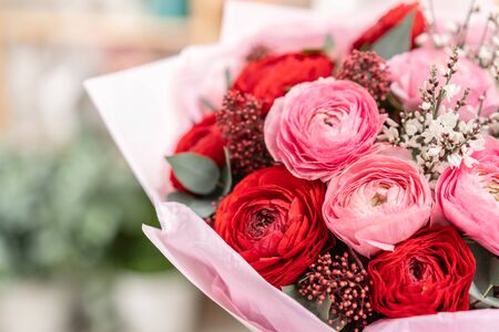 Beautiful bouquet of mixed flowers in womans hands. the work of the florist at a flower shop. Handsome fresh bouquet. Flowers deliveryの写真素材