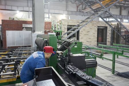 Nizhny Novgorod, Russia - October 30 2019. Plant KM PRECAST. Workers working with metal, welding...