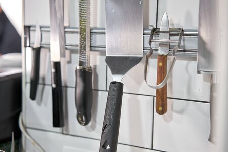 Set of knives on magnetic holder in the kitchen. Restaurantの写真素材