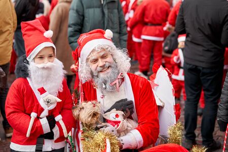 Riga, Latvia - December 08 2019. Unidentified participants of annual Santas Fun Run & Walk on December. Riga Santas Race start on Christmas market on Dome Square, in the Old Town.のeditorial素材