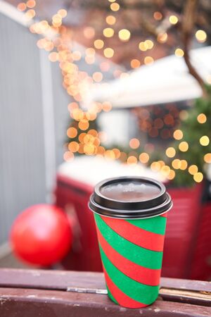 closeup cup of mulled wine with blurred background of winter wonderland, a Christmas Market in European small city.の写真素材