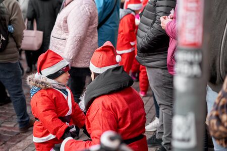 Riga, Latvia - December 08 2019. Unidentified participants of annual Santas Fun Run & Walk on...