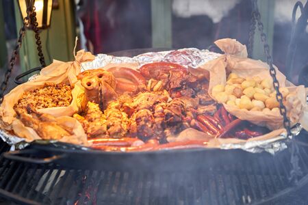 Riga, Latvia - December 09 2019. Preparation of meat and national dishes over an open fire, as well as hot wine, mulled wine. Christmas market on Dome Square, in the Old Townのeditorial素材