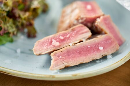 Closeup Medium rare tuna with lettuce and hot sauce. Restaurant menuの写真素材