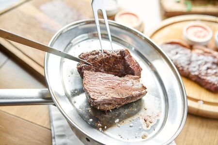 Various grilled meat set with Pickled cabbage and two sauces. Serving on a wooden Board. Barbecue...