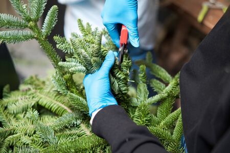 A woman decorates a Christmas arrangement. Master class on making decorative ornaments. Christmas...