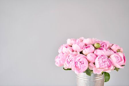 Pink Angel Cheeks peonies in a metal vase. Beautiful peony flower for catalog or online store. Floral shop concept . Beautiful fresh cut bouquet. Flowers deliveryの写真素材