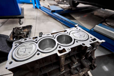 New pistons and cylinder head of engine block vehicle. Motor capital repair. Sixteen valve and four cylinder. Car service concept. The job of a mechanic. Old and new pistons.の写真素材