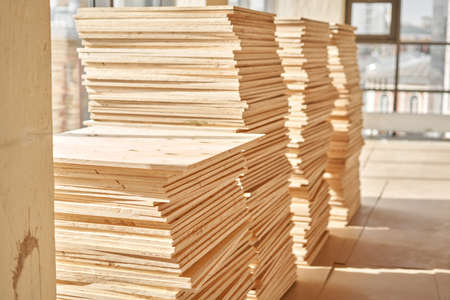 Plywood boards on the industry. layer of plywood, Construction site preparation for the flooring of the parquet floor. Restoration of the floor in a restaurant or apartment.の写真素材