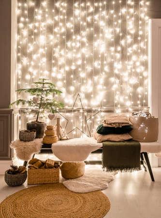 Classic apartments with decorated christmas tree and presents. Christmas evening in the light of candles and garlands. Living with fireplace and stucco.の写真素材