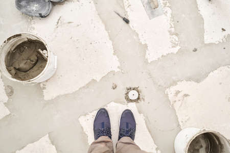 Large Ceramic tiles in the loft style, concrete. Repair of the dining room in the house, place for kitchen, floor covering change. Empty interior for design, gray concrete wall.の写真素材