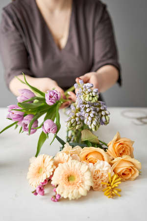 Unpacking Flowers bunch, set for home. Fresh cut flowers for decoration home. European floral shop. Delivery fresh cut flower.の写真素材