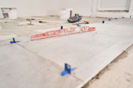 Large Ceramic tiles in the loft style, concrete. Repair of the dining room in the house, place for kitchen, floor covering change. Empty interior for design, gray concrete wall.の写真素材