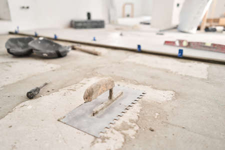 Large Ceramic tiles in the loft style, concrete. Repair of the dining room in the house, place for kitchen, floor covering change. Empty interior for design, gray concrete wall.の写真素材