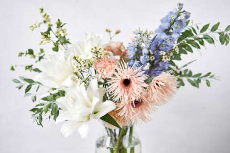 Finished flower arrangement in a vase for home. Flowers bunch, set for interior. Fresh cut flowers for decoration home. European floral shop. Delivery fresh cut flower.の写真素材