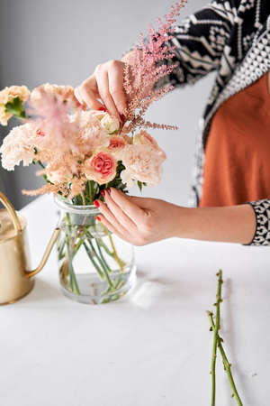 Step by step installation of flowers in a vase. Flowers bunch, set for home. Fresh cut flowers for decoration home. European floral shop. Delivery fresh cut flower.の写真素材