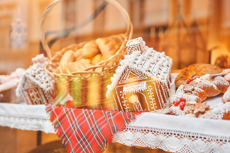 A bakery showcase in a European city for Christmas. Gingerbread house, pretzel, apple crumble, buns. Bread on Christmas and New yearの写真素材